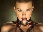Bondage Woman in Leather Straps and Chains